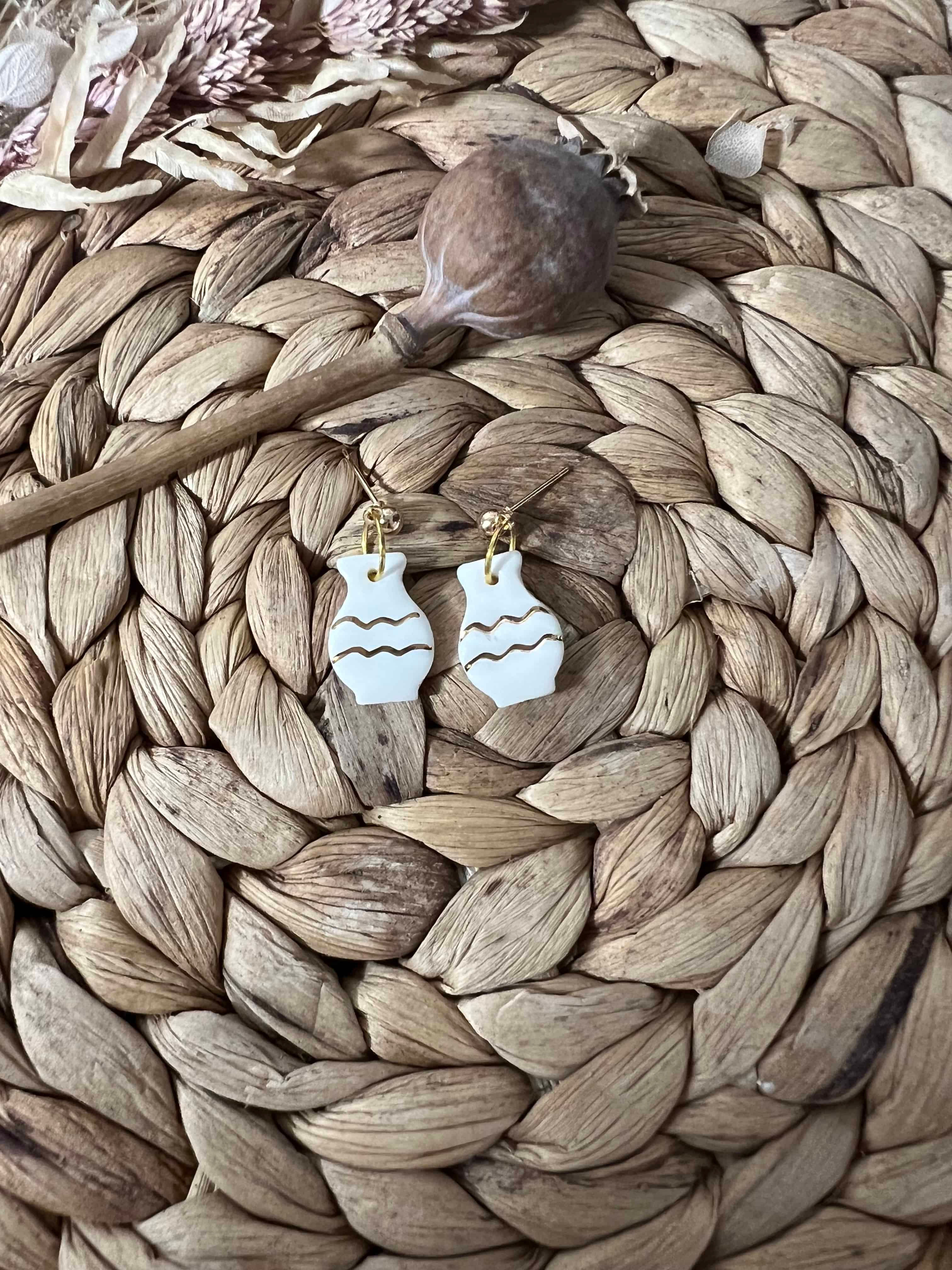 White handmade ceramic earrings in vase shape, with gold plated ball studs.