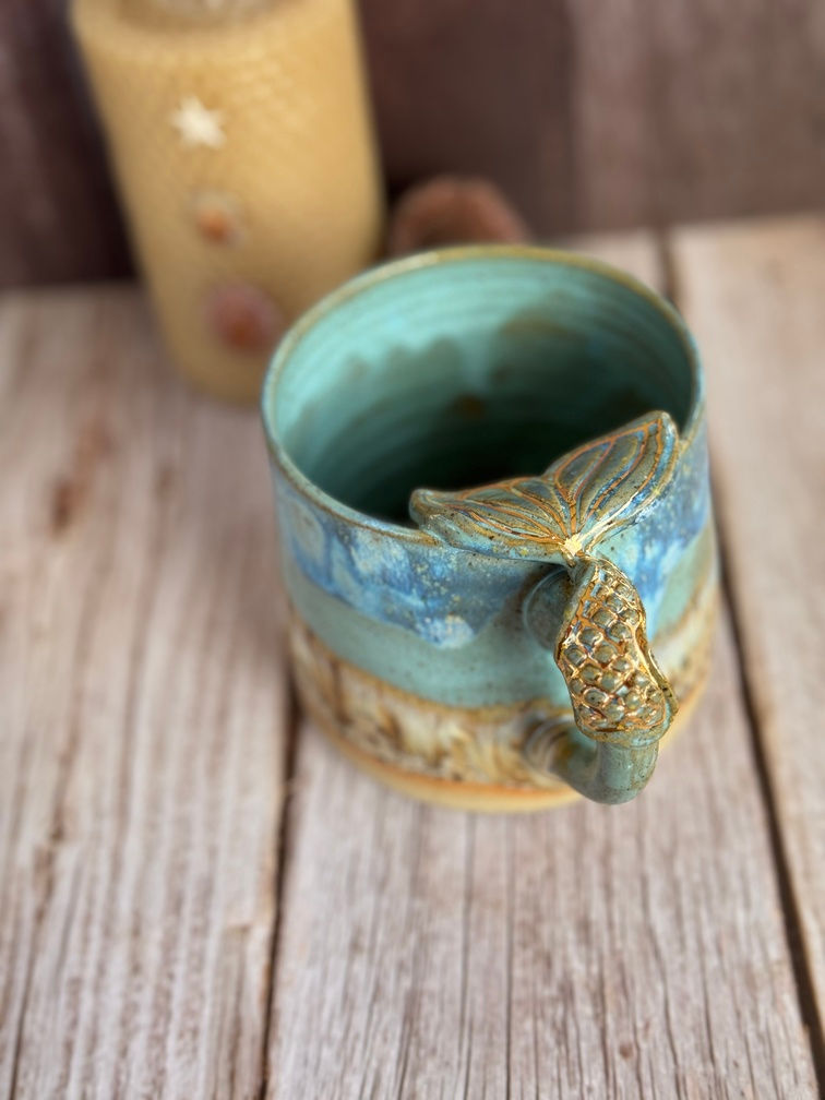 Close up of the mermaid tail handle and gold detailing