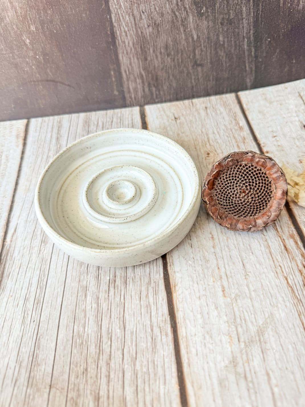 White ceramic sopnge dish on timber background