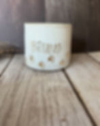 White speckled mug with gold text saying "Bruno" and paw prints lined in gold