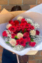 Dozen red roses with white and blush accent flowers