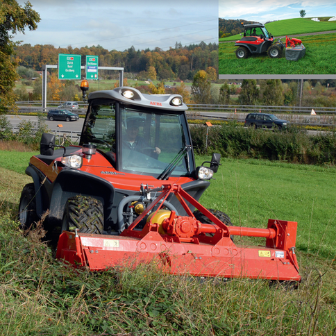 A red and black tractor with a red mower on the front.