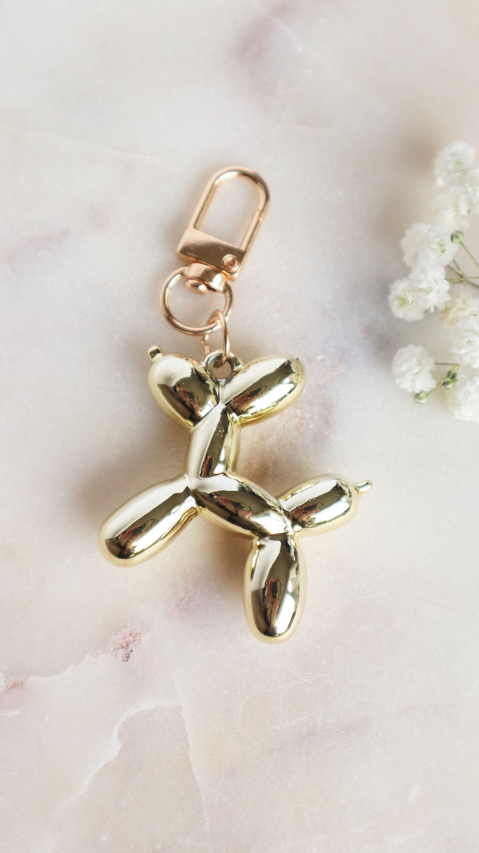 Bag charm in de vorm van een gouden ballon hond