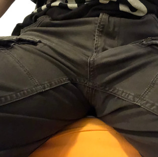 Packing with as-is packer, front view in cargo pants, sitting down with legs spread