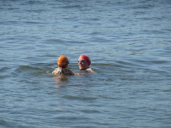 coach and nervous swimmer in open water