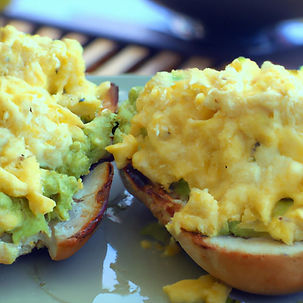 avocado spread fluffy scrambled eggs, and melted cheese, golden toasted open-faced bun