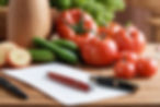 A photo collage like dreamy kitchen background with some produce on a wood cutting board a