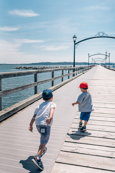 A picture of two kids running out to the pier in Vancouver.