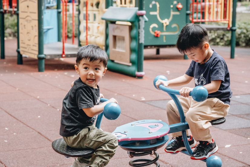 Brothers playing the teeter totter at Lai Chi Kok Park.