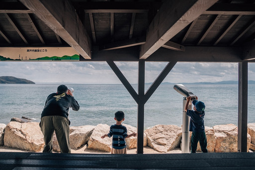 Father and 2 boys playing at the twenty-four eyes movie studio.