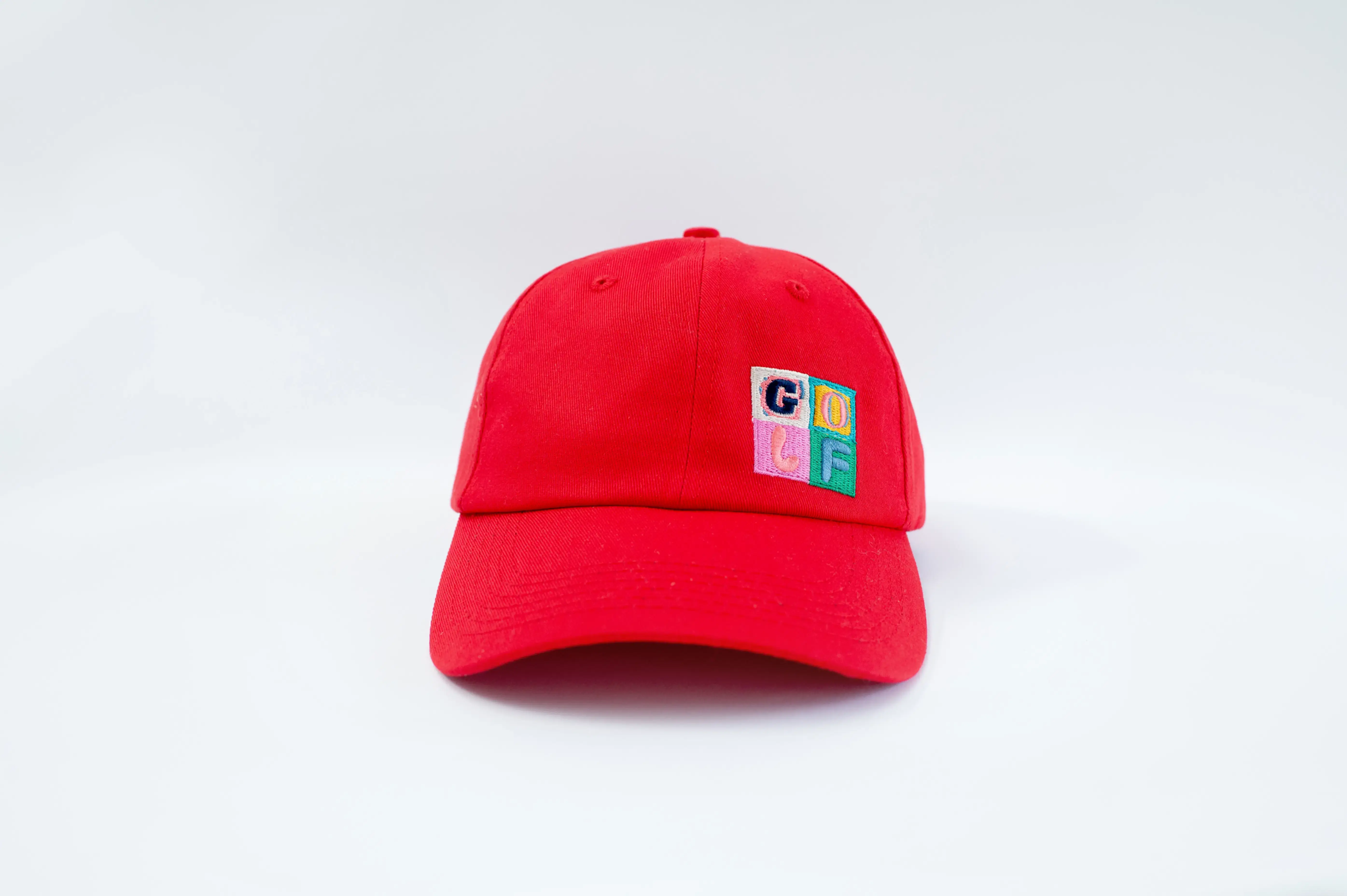 Red baseball cap with colorful GLF logo