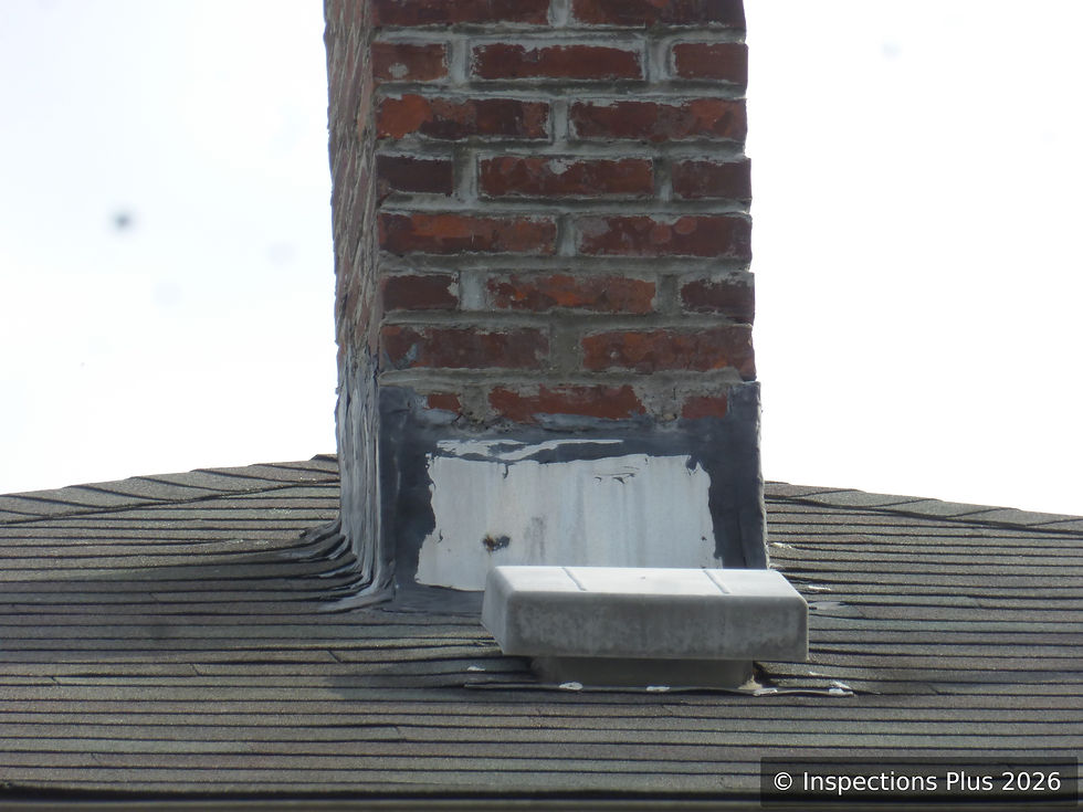 Exterior roof transition with chimney and adjacent roof surfaces viewed during a Massachusetts inspection.