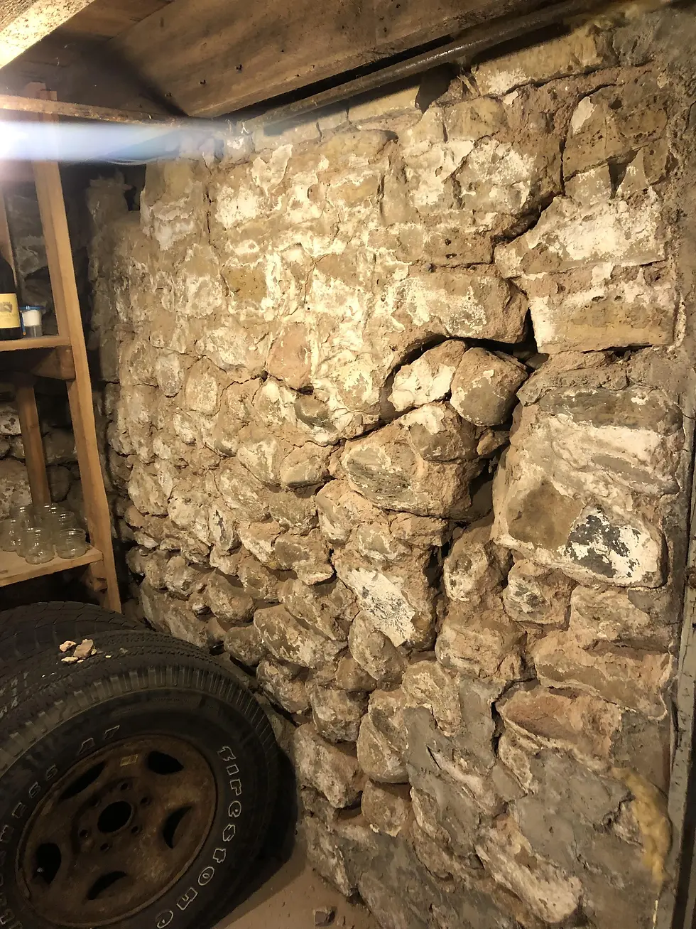 fieldstone foundation showed significant displacement and movement.
