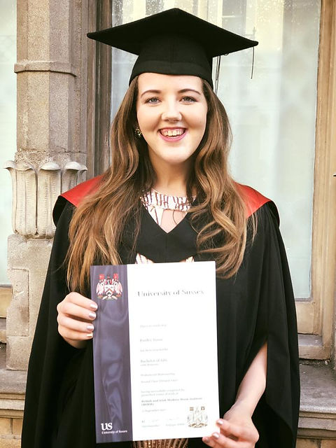 Young lady at graduation with certificate