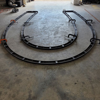 Metal frame layers pieces on to the beginning stages of a metal horseshoe conference table being built inside the Dark Horse Metal Works custom fabrication and welding shop in Granbury.