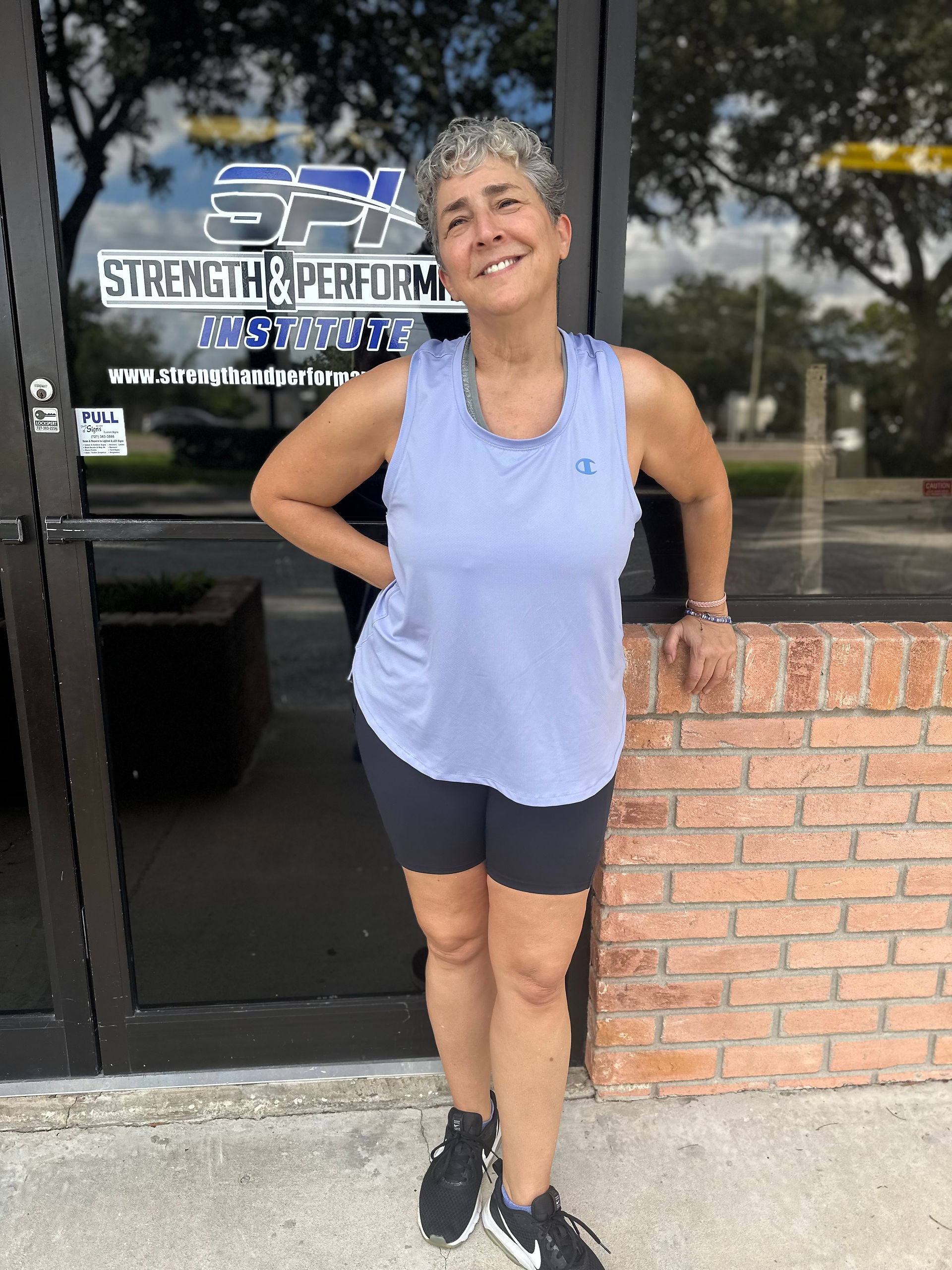 Personal training client posing in front of the Strength & Performance Institute in Clearwater, FL