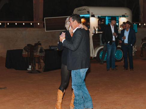 A couple dancing on the packed dirt at the hood county Stampede gala