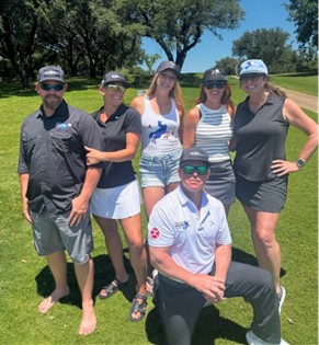 Volunteers and members of the Hood County Stampede at a golf event doing community outreach