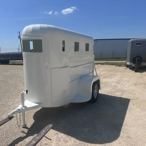 Fully restored white one horse 1960 CC Lite horse trailer at the Dark Horse Metal Works shop in Granbury