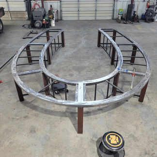 Putting the framework into place on a metal horseshoe shaped conference table being built inside Dark Horse Metal Works in Granbury, TX