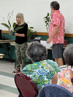 Laurie Nissen presenting how to prepare orchids for display and judging at Tampa Orchid Club meeting