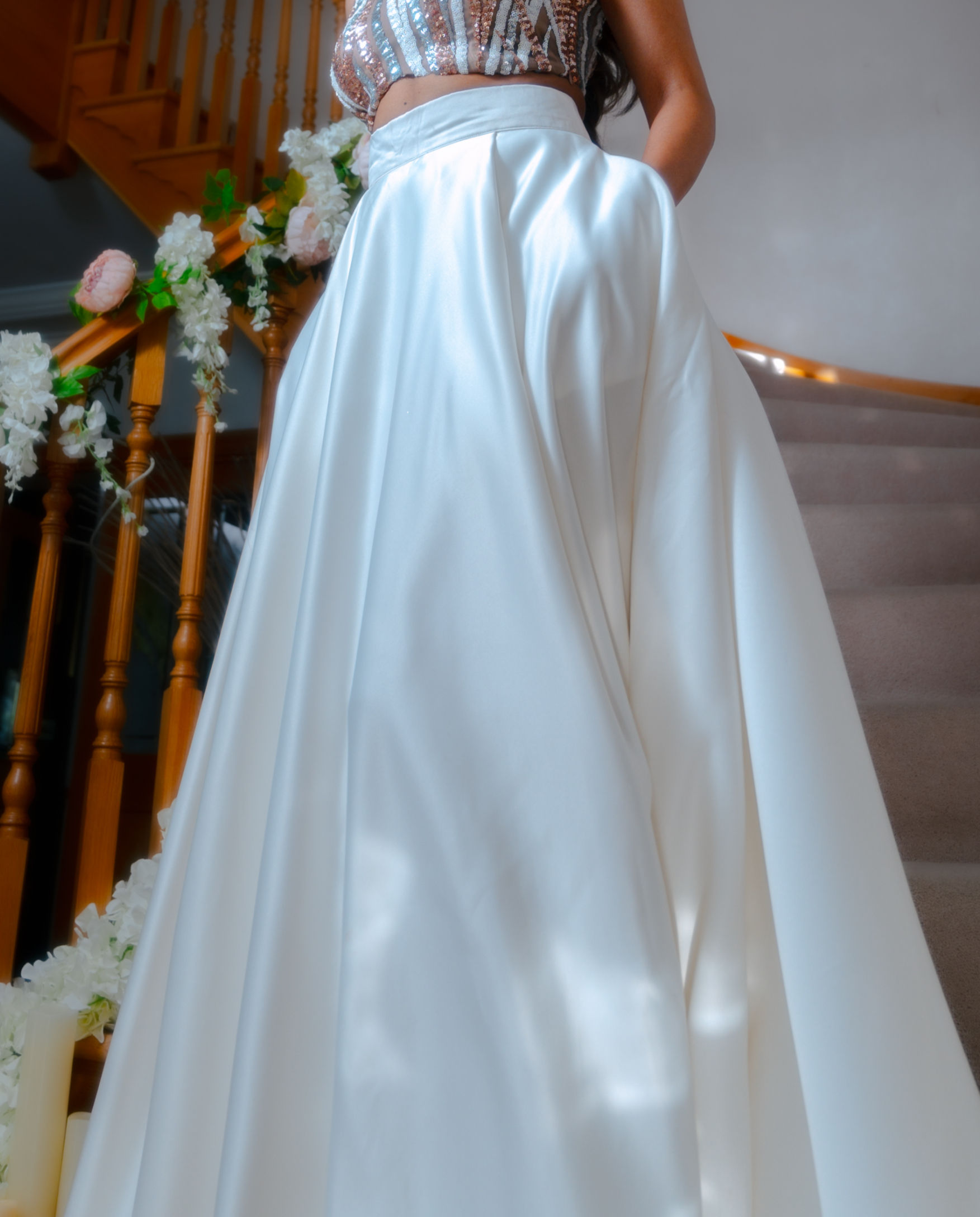 White satin skirt with pockets on a staircase