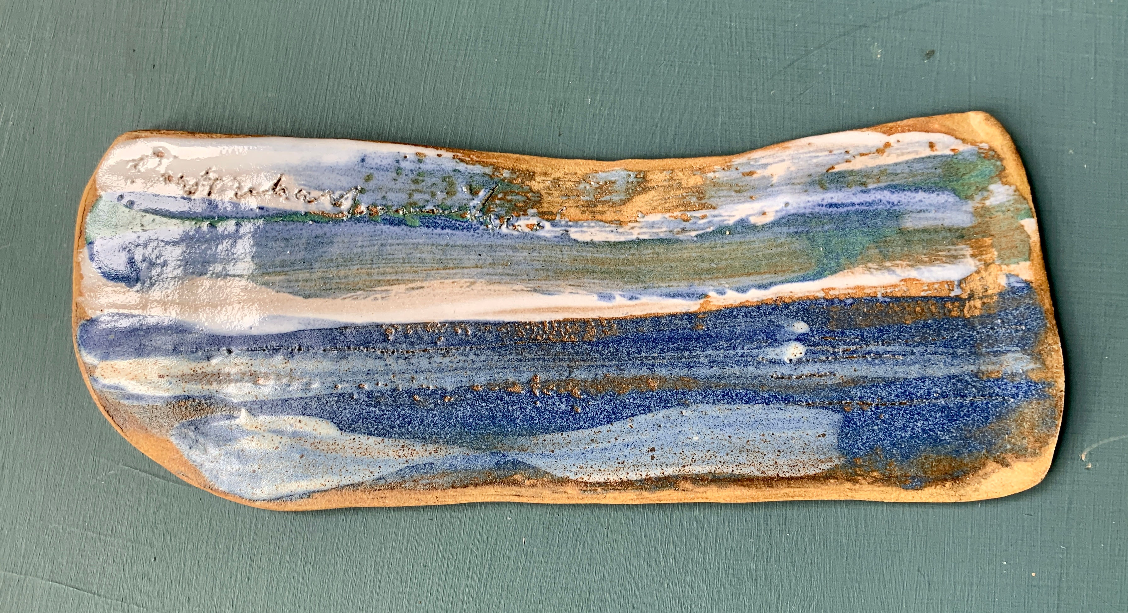 Stoneware landscape tile.