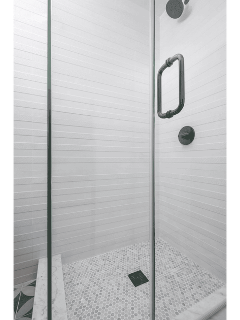 shower with black hardware and white walls