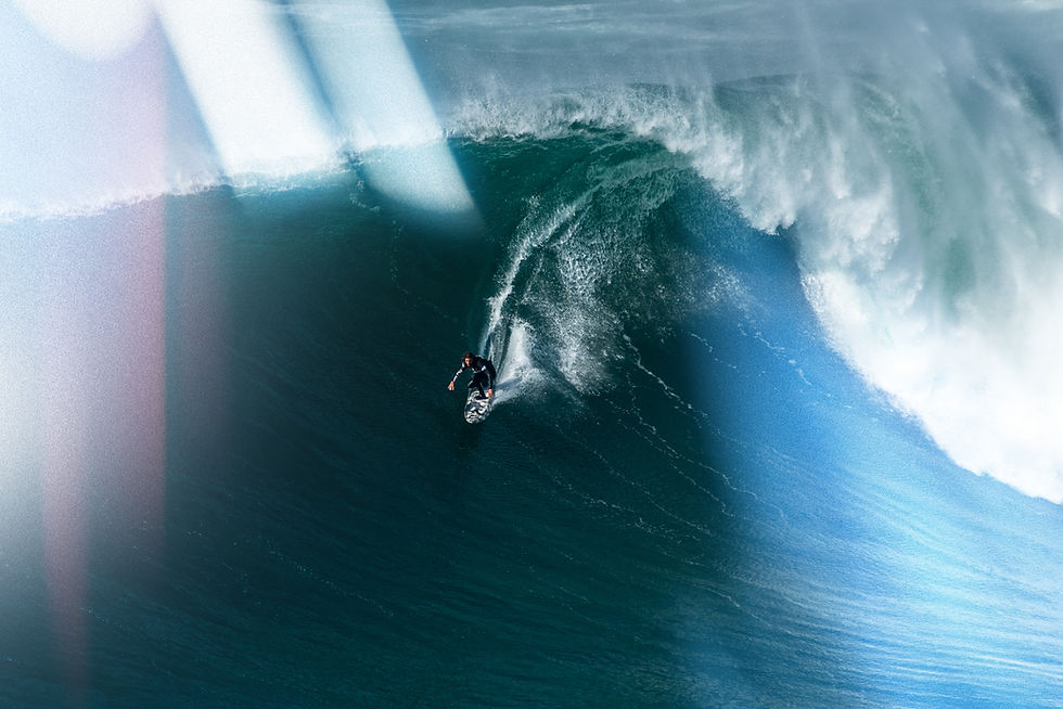 Surfer riding a massive ocean wave