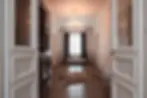 Open doors leading into a hallway with a chandelier and a window. My Site 9