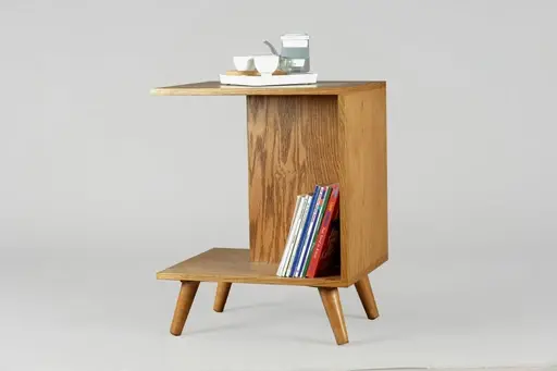 Wooden side table with books, tea set, and a simple design.