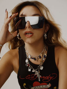 hailey hermida poses for her electronic rock pop music song dare me and eye for an eye, with fur boots and sunglasses