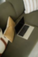 Laptop resting on a comfortable couch, representing a secure and convenient space for virtual individual and EMDR therapy ses