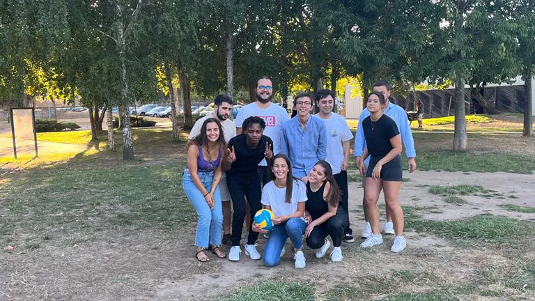 Trainees gathered in the middle of the park, posing with a volleyball
