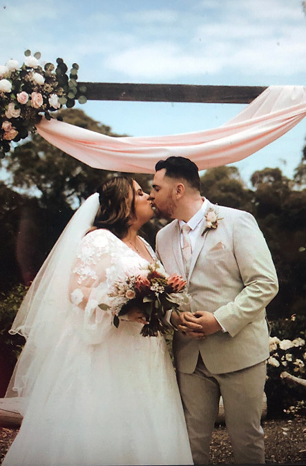 A wedding photo displayed on a computer screen, capturing a joyful moment of celebration and love between the couple.