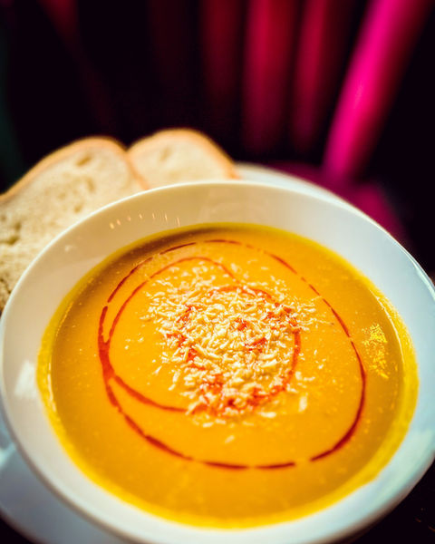 Sweet potato and coconut soup with chilli oil drizzle and freshly baked sour dough
