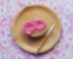 cherry blossom wagashi on a bamboo plate