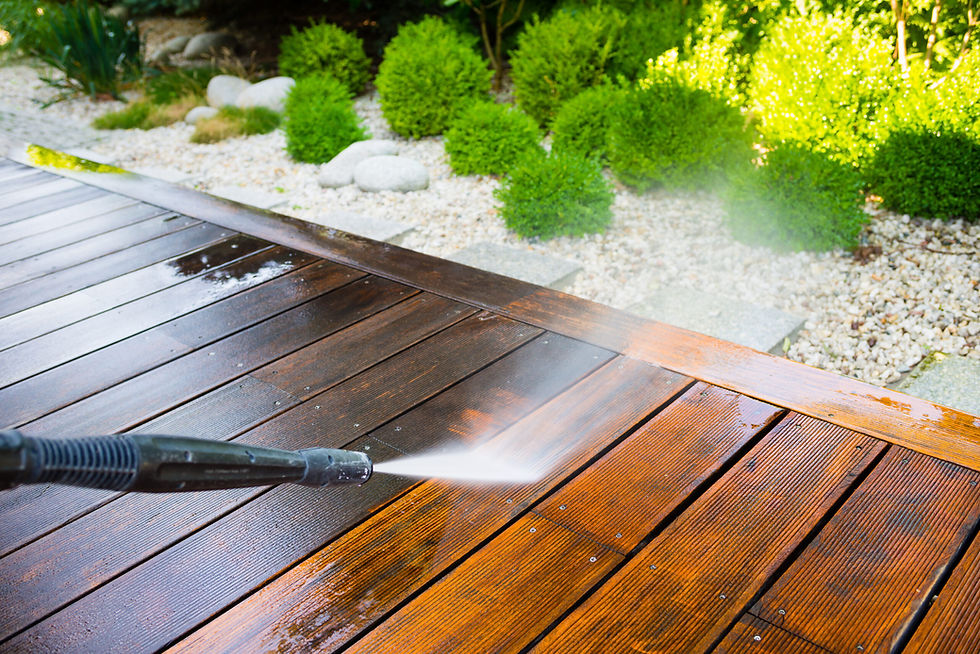 Power washer cleaning wooden deck