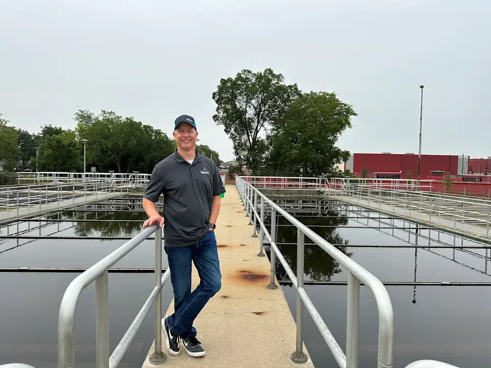 Image: Chris (Founder and CEO) stands at the Barrington IL, a Waterly customer, wastewater treatment plant.