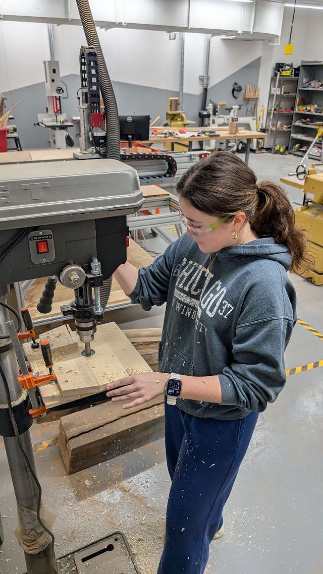 Student uses a wood cutter 