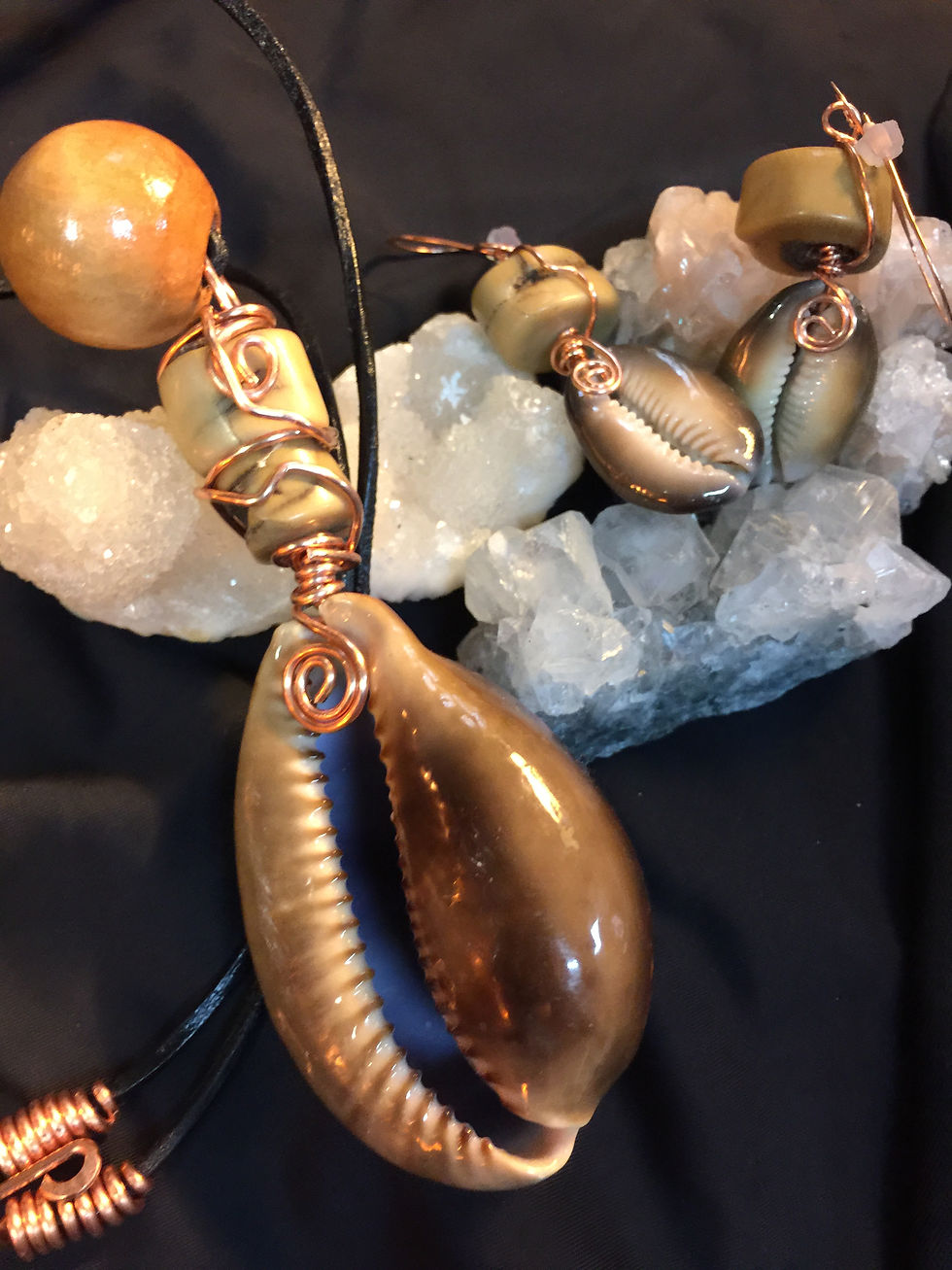 Large brown cowrie amulet and earrings set.