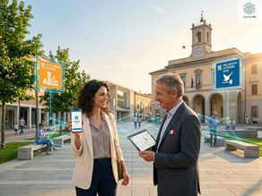 Fotografia ambientata in una piazza italiana soleggiata e moderna. In primo piano, una donna sorridente mostra lo schermo di uno smartphone con una spunta verde e la scritta 'Segnalazione inviata'. Di fronte a lei, un uomo in abito formale con una spilla della bandiera italiana (rappresentante un amministratore locale) sorride e tiene un tablet. Sopra di loro, elementi grafici olografici fluttuanti e luminosi: a sinistra l'icona arancione dell'SDG 11 'Città e Comunità Sostenibili', a destra l'icona blu dell'SDG 16 'Pace, Giustizia e Istituzioni Solide'. In alto al centro, il testo: 'AGENDA 2030: DAL DIRE AL FARE.'. Linee di rete digitali azzurre connettono visivamente le persone, i dispositivi e le icone degli obiettivi, simboleggiando la collaborazione civic-tech.
