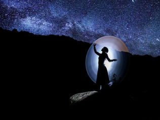 A woman in a mystical bubble at night.