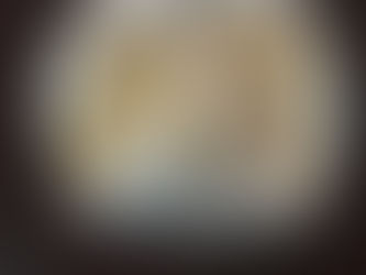 A pendant embossed with tiny gold baby feet and a heart in the center