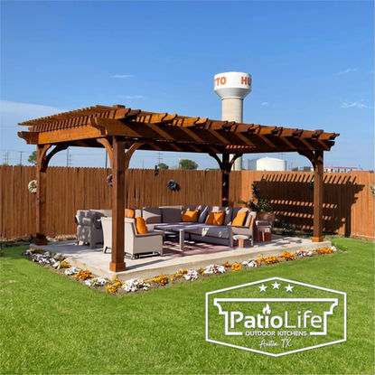 Decorative custom pergola with unique double rafter design, with stained cedar in Hutto, TX backyard patio.
