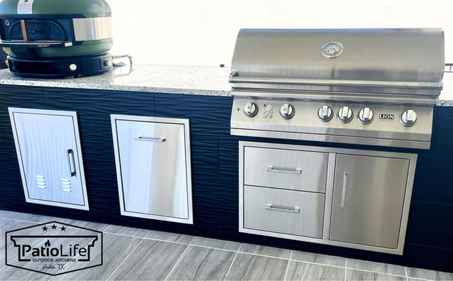 Custom modern black outdoor kitchen with black wavy tile, built-in Lion BBQ grill, and a Gozney pizza oven in Austin, TX