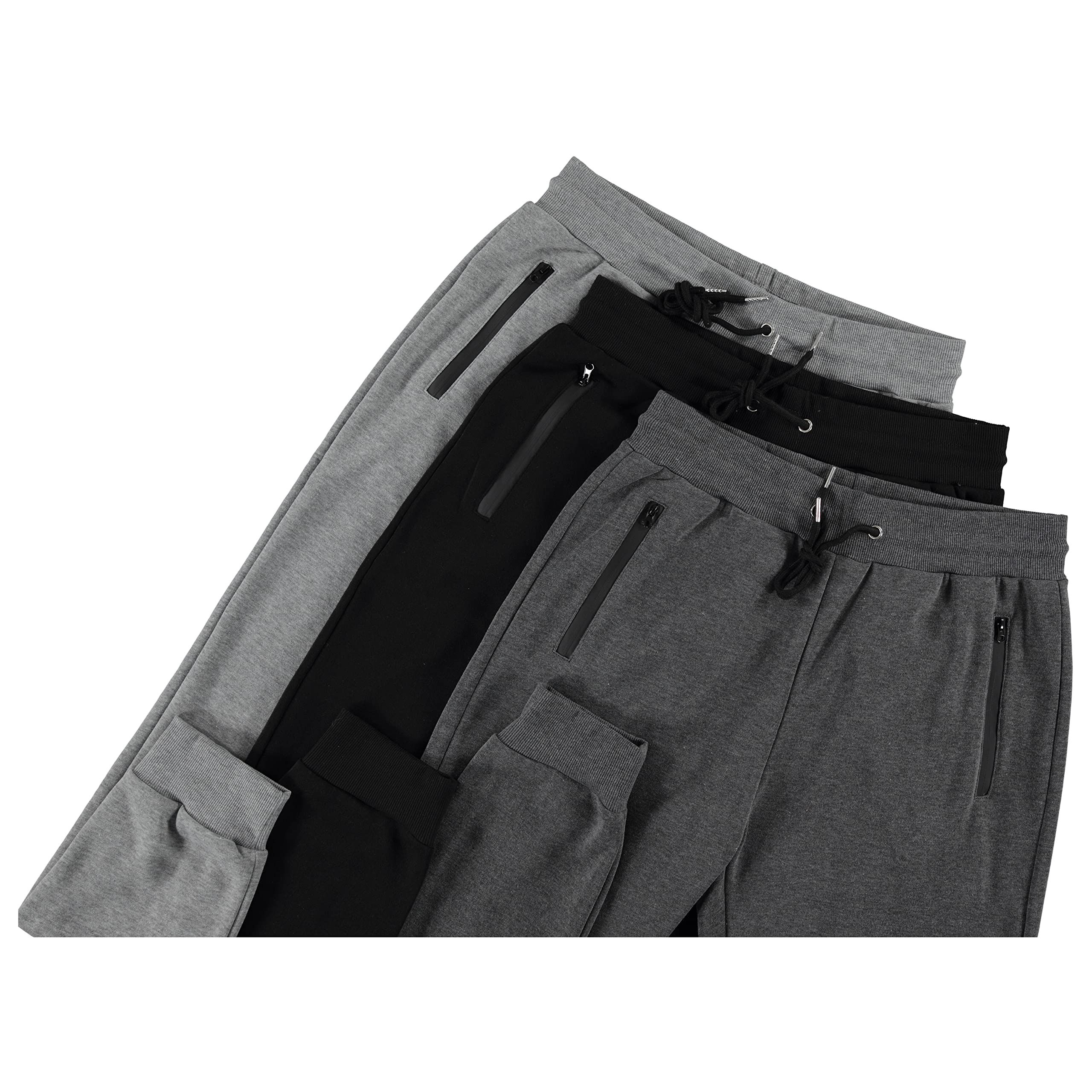 Four pairs of gray, black, and dark gray athletic pants, angled on white