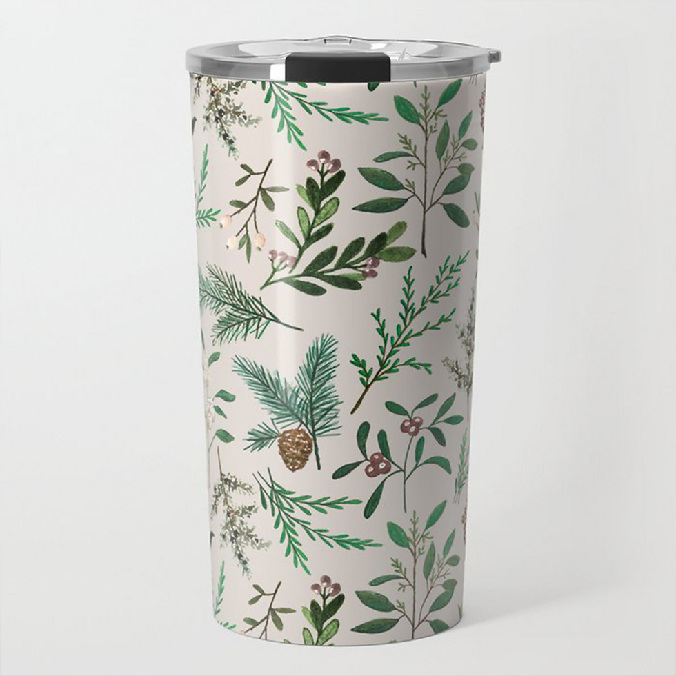 Floral travel mug with various painted green leaves and a beige background.