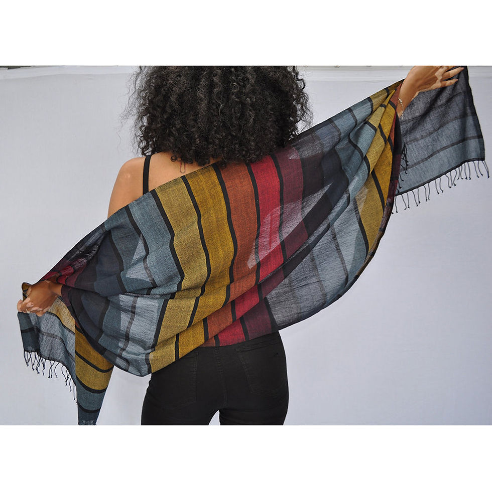 Woman holds a colorful scarf with stripes; perfect for any occasion.