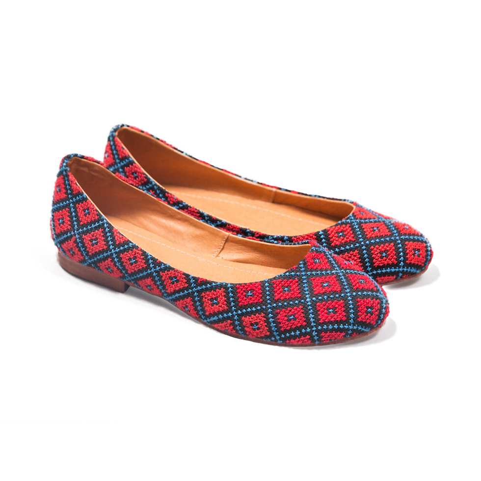 Pair of colorful patterned ballet flats on a white background.
